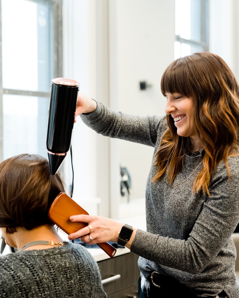Woman getting professional haircut at salon